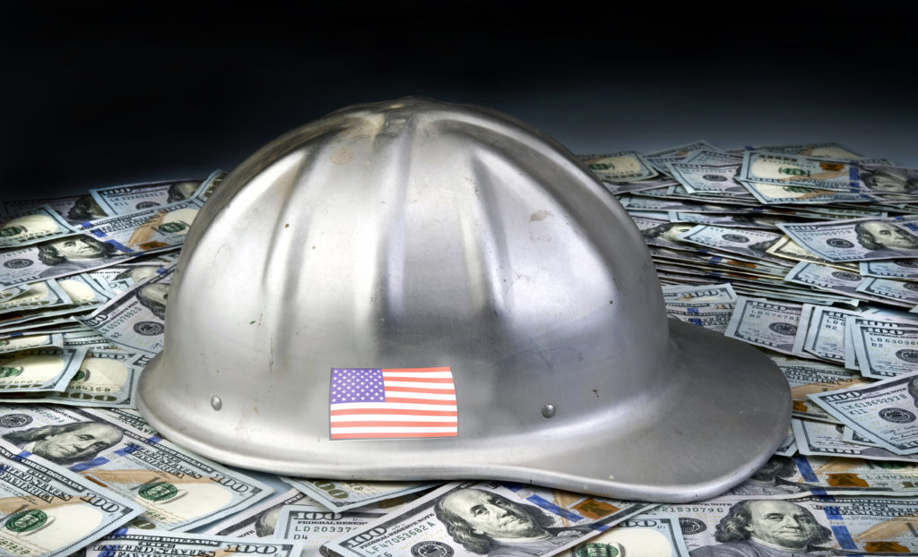 Make American strong again with hard hat on top of Hundred dollar bills.