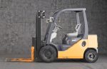 Forklift standing on industrial dirty concrete wall background