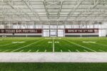 Whether inside or outside, Texas A&M aims for football excellence with a lift from Schweiss Doors Schweiss